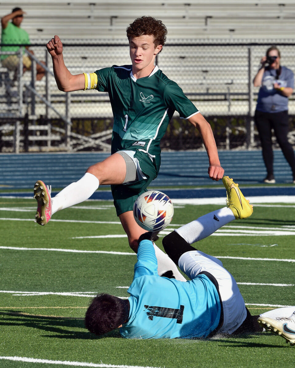 Beaufort’s Sam Trask collides with the Georgetown goalkeeper during the second round of the Class 3A Lower State playoffs Wednesday, May 3. The Eagles scored their first two goals during the first 90 seconds of the game and went to defeat the Bulldogs, 5-2. Bob Sofaly/The Island News