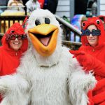 Molly Dennis, left, and Tammy Johnson, right, take time out to pose with the Hunting Island Pelican (Laura Boozer) prior to the start of the 13th annual Pelican Plunge on Sunday, Jan. 1, 2023 at Hunting Island State Park. Photo by Bob Sofaly/File/The Island News