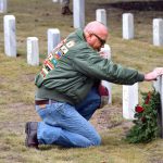 U.S. Marine Corps veteran Walt Field says a silent prayer after placing a wreath at the headstone of Benjamin Howard during the annual Wreaths Across America Day on Saturday, Dec. 16, at the Beaufort National Cemetery. Field said he places the wreath, says a silent prayer and says the deceased veteran’s name out loud before placing a penny on the headstone before leaving. Wreaths were placed on more than 26,000 head stones Saturday. Bob Sofaly/The Island News