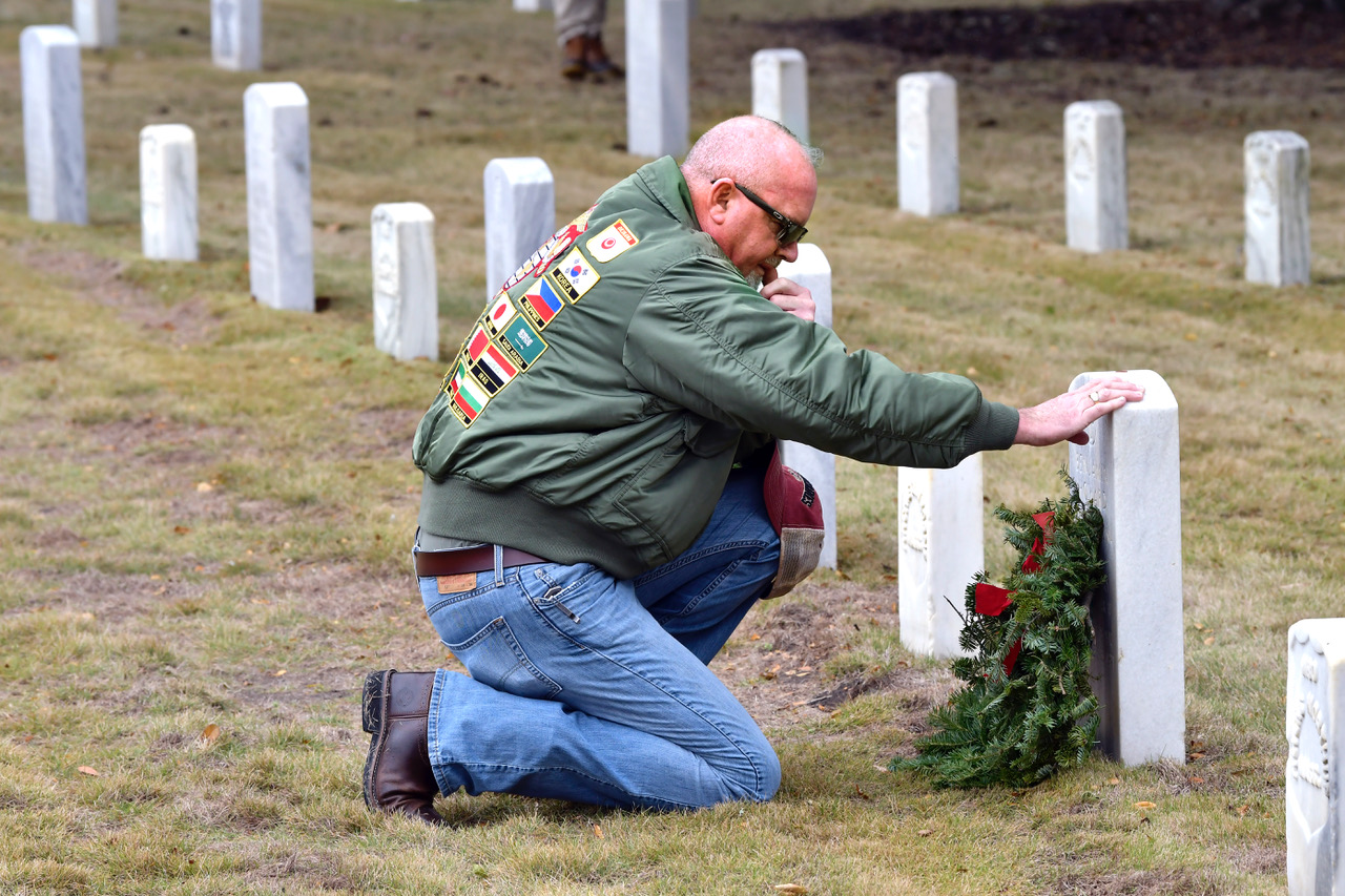 U.S. Marine Corps veteran Walt Field says a silent prayer after placing a wreath at the headstone of Benjamin Howard during the annual Wreaths Across America Day on Saturday, Dec. 16, at the Beaufort National Cemetery. Field said he places the wreath, says a silent prayer and says the deceased veteran’s name out loud before placing a penny on the headstone before leaving. Wreaths were placed on more than 26,000 head stones Saturday. Bob Sofaly/The Island News