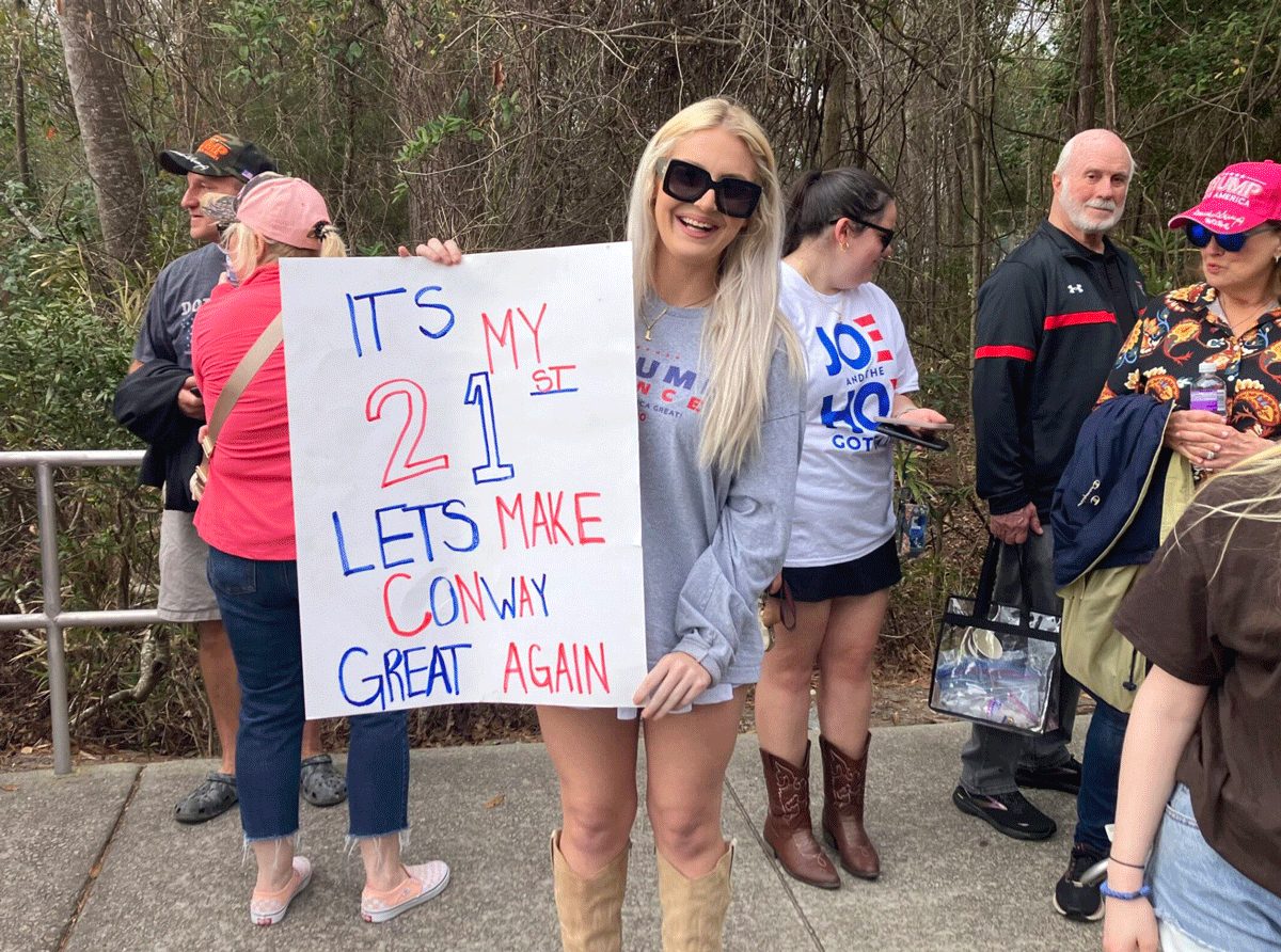 Shea Turner poses for a photo with her sign for the Donald Trump rally at Coastal Carolina University on Saturday, Feb. 10, 2024 – her birthday. Abraham Kenmore/S.C. Daily Gazette
