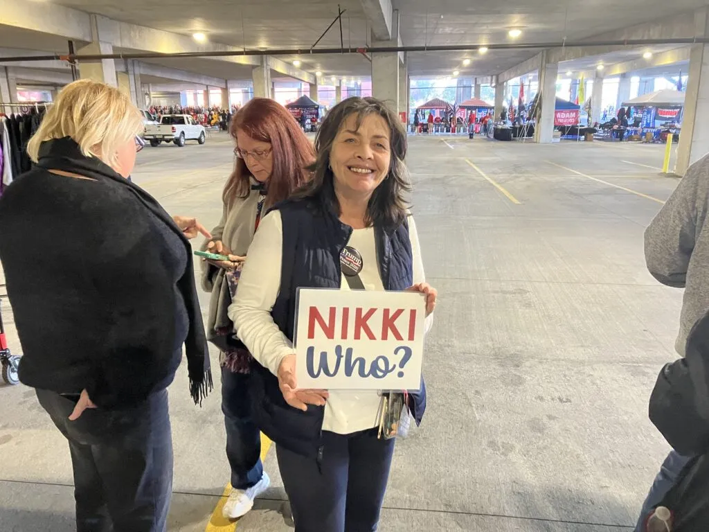 Kim Cessna poses with her “Nikki Who?” sign in line for Donald Trump’s rally in North Charleston on Feb. 14, 2024. Abraham Kenmore/S.C. Daily Gazette