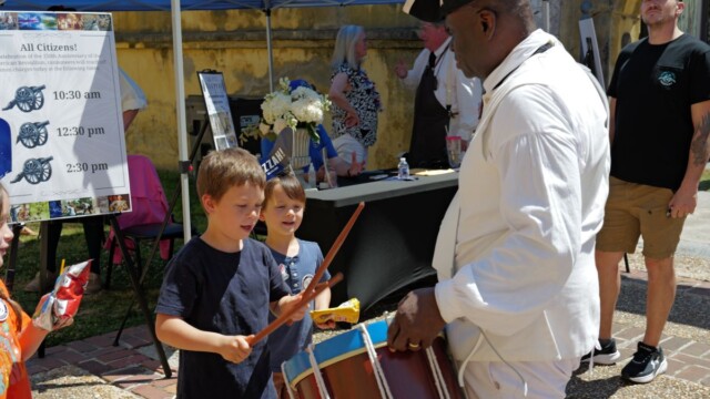 Rowan Kurth of Beaufort tries his hand at battlefield drumming instructed by Ken Seward of Columbia. Visitors stepped into the 18th century during a public program featuring interactive demonstrations, battlefield simulations, live cannon fire and the immersive film “Beaufort on the Brink of Revolution” at the Beaufort History Museum’s Family Day on Saturday, April 11, 2026, at the Beaufort Arsenal. Asa Aarons Smith/The Island News